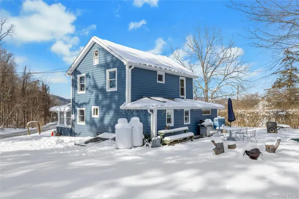 a view of a house with a yard covered in snow