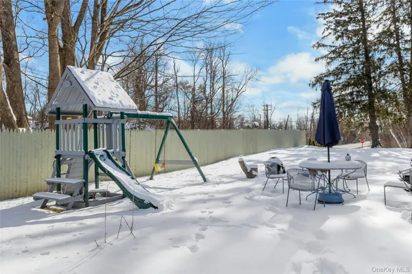 a view of a patio with a table and chairs