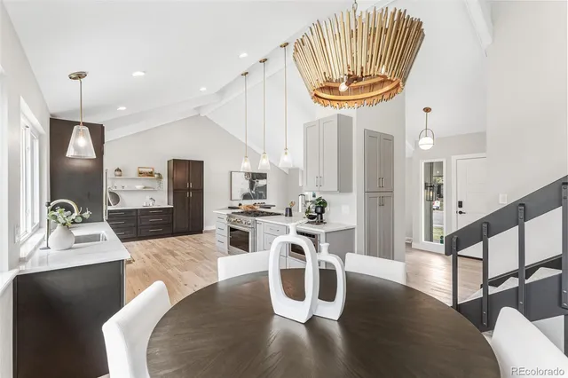 a living room with furniture a chandelier and wooden floor