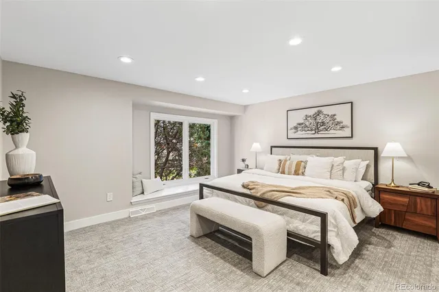 a bedroom with a bed and a large window