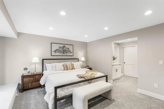 a bedroom with a large bed and a chandelier