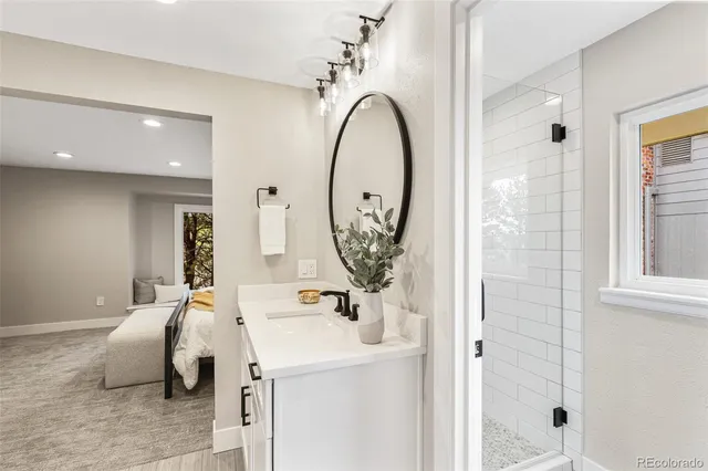 a bathroom with a sink a mirror and a shower