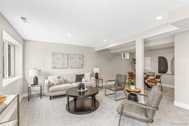 a living room with furniture and a potted plant