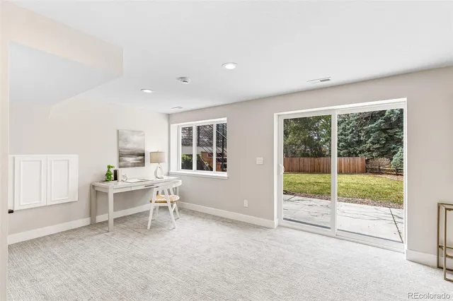 a view of work space with wooden floor and windows