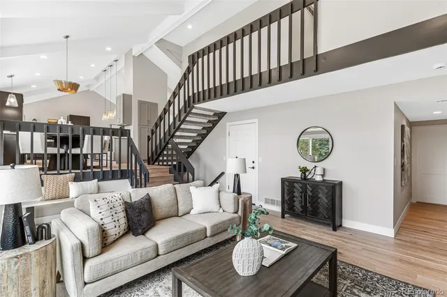 a living room with fireplace furniture and a wooden floor