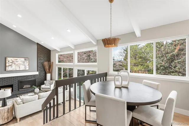 a dining room with furniture a chandelier and window