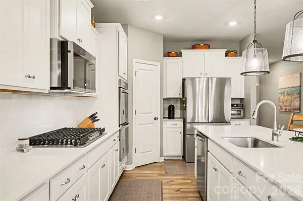 a kitchen with stainless steel appliances a refrigerator sink and cabinets