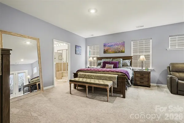 a bedroom with a bed and a large window