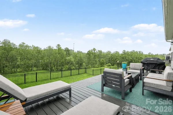 a view of a roof deck with couches and sky view