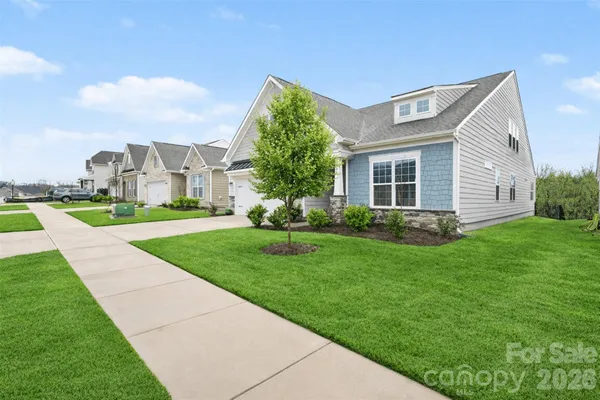 a front view of house with yard and green space