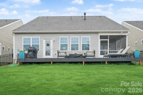 a view of a house with a backyard and a patio