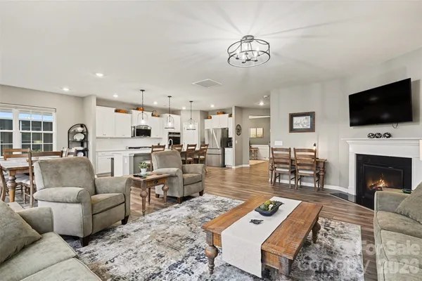a living room with furniture a flat screen tv and a fireplace