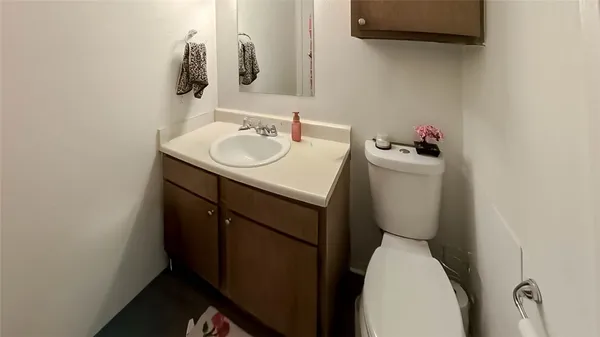 a bathroom with a sink toilet and a mirror
