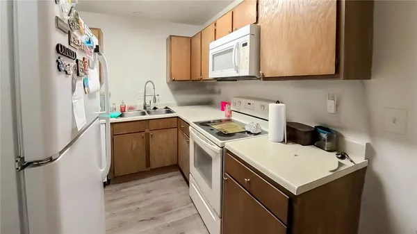 a utility room with sink a washer and dryer