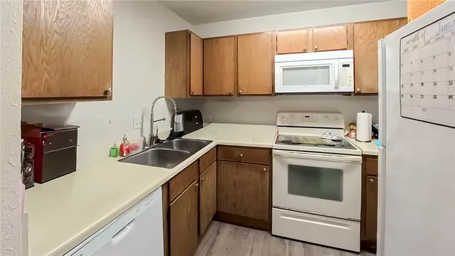 a kitchen with a sink cabinets and appliances
