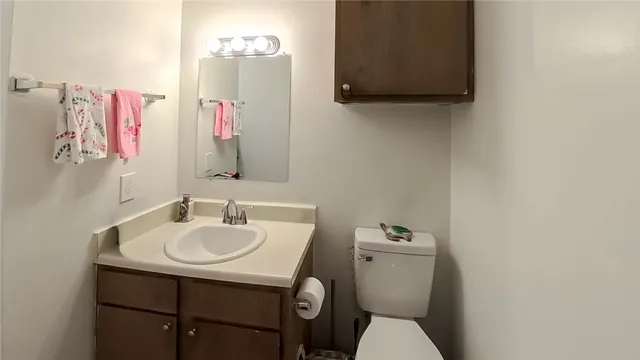 a bathroom with a sink mirror and toilet