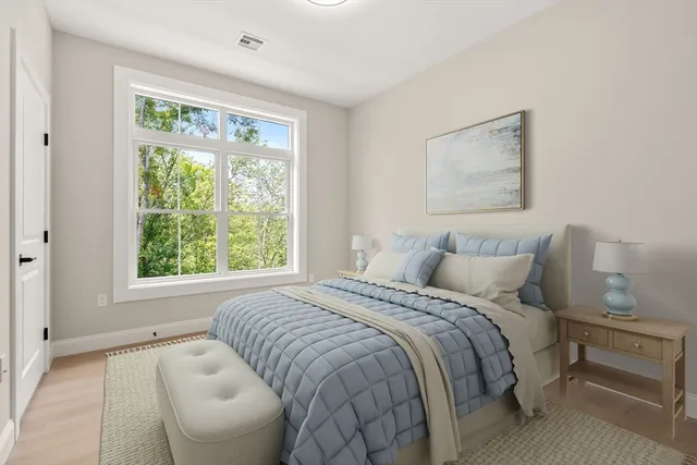 a bedroom with a bed and a large window