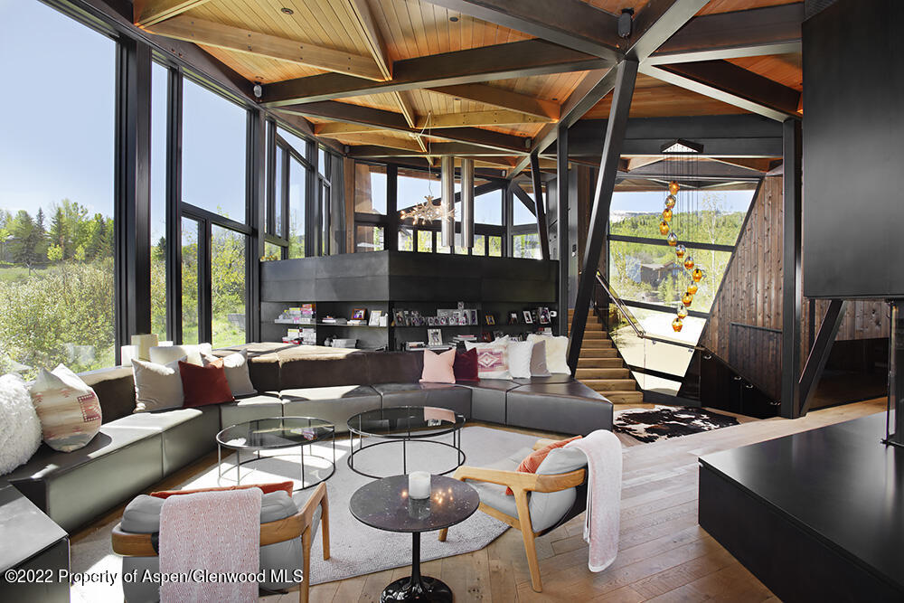 27 Turkey Trot Court Snowmass Village, CO 81615 - Photo 11 of 45 a living room with furniture fireplace and a large window