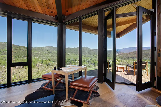 a bedroom with furniture and large windows