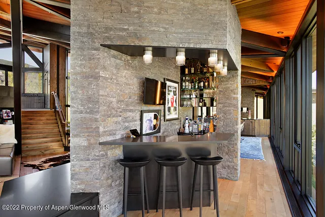 a front view of a house with outdoor seating