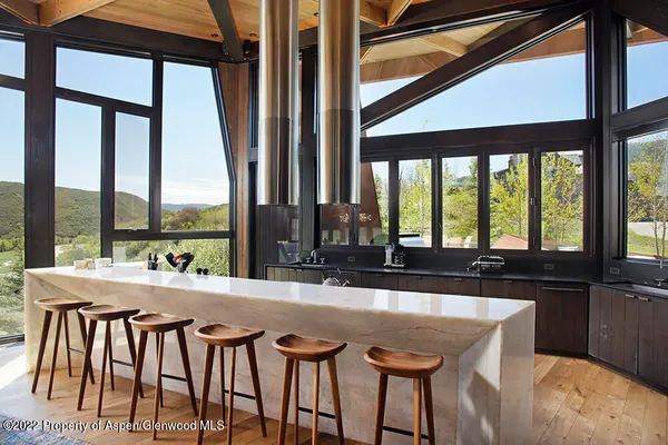 a room with furniture and large windows