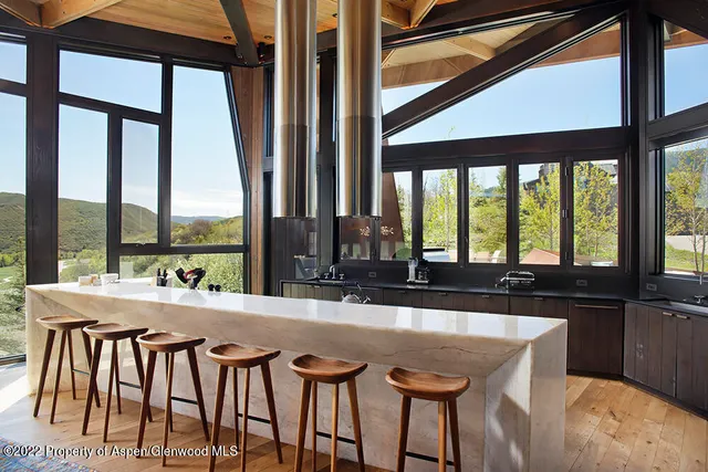 a room with furniture and large windows