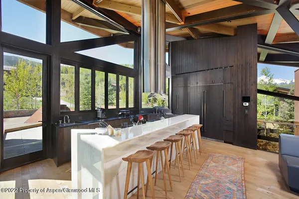 a kitchen with a table chairs and a refrigerator