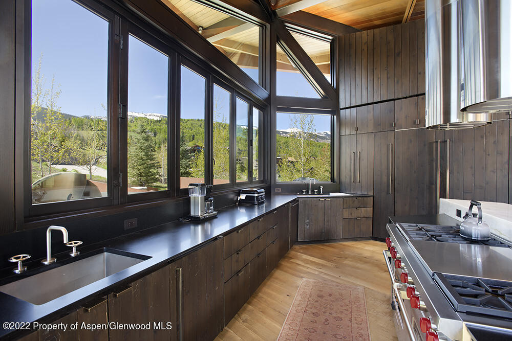27 Turkey Trot Court Snowmass Village, CO 81615 - Photo 19 of 45 a kitchen with stainless steel appliances granite countertop a sink a stove and a refrigerator