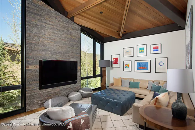 a living room with furniture and a painting on the wall