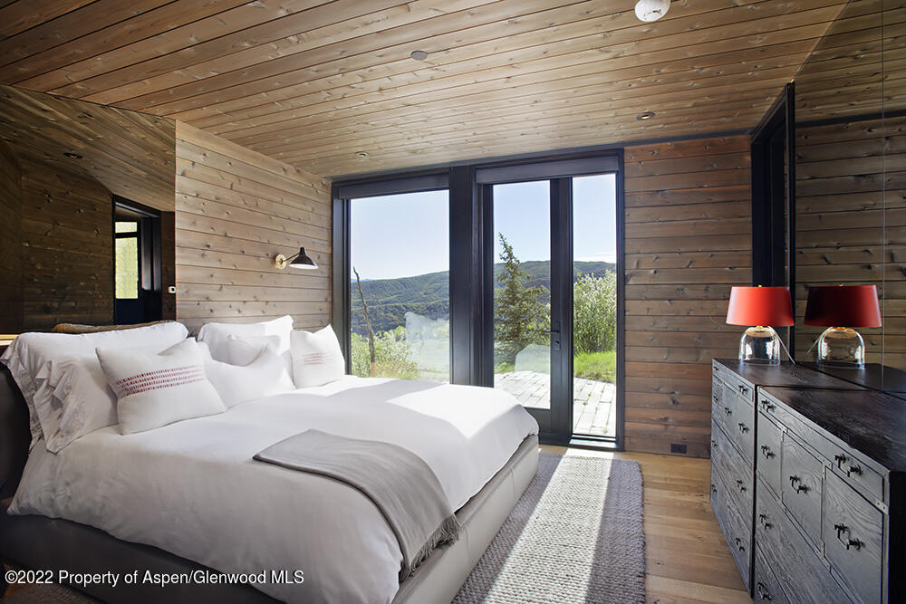 27 Turkey Trot Court Snowmass Village, CO 81615 - Photo 28 of 45 a large white bed sitting in a bedroom next to a large window