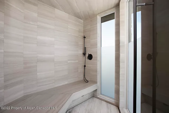 a bedroom with a large bed and a large window