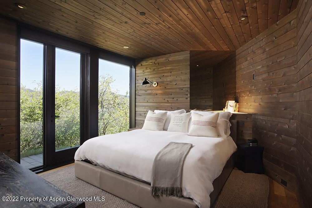 27 Turkey Trot Court Snowmass Village, CO 81615 - Photo 33 of 45 a bedroom with a large bed and a large window