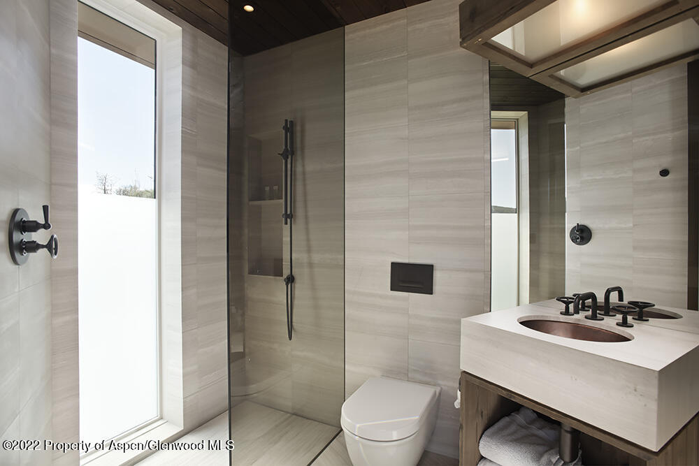 27 Turkey Trot Court Snowmass Village, CO 81615 - Photo 37 of 45 a bathroom with a sink toilet a mirror and shower