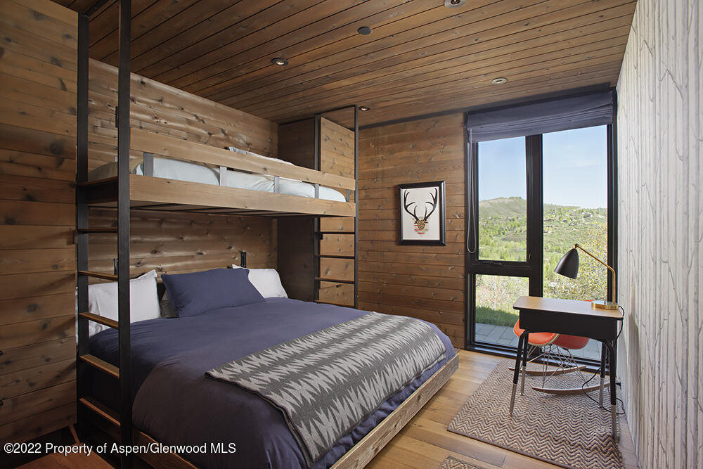 27 Turkey Trot Court Snowmass Village, CO 81615 - Photo 40 of 45 a bedroom with a bed a dresser next to a window