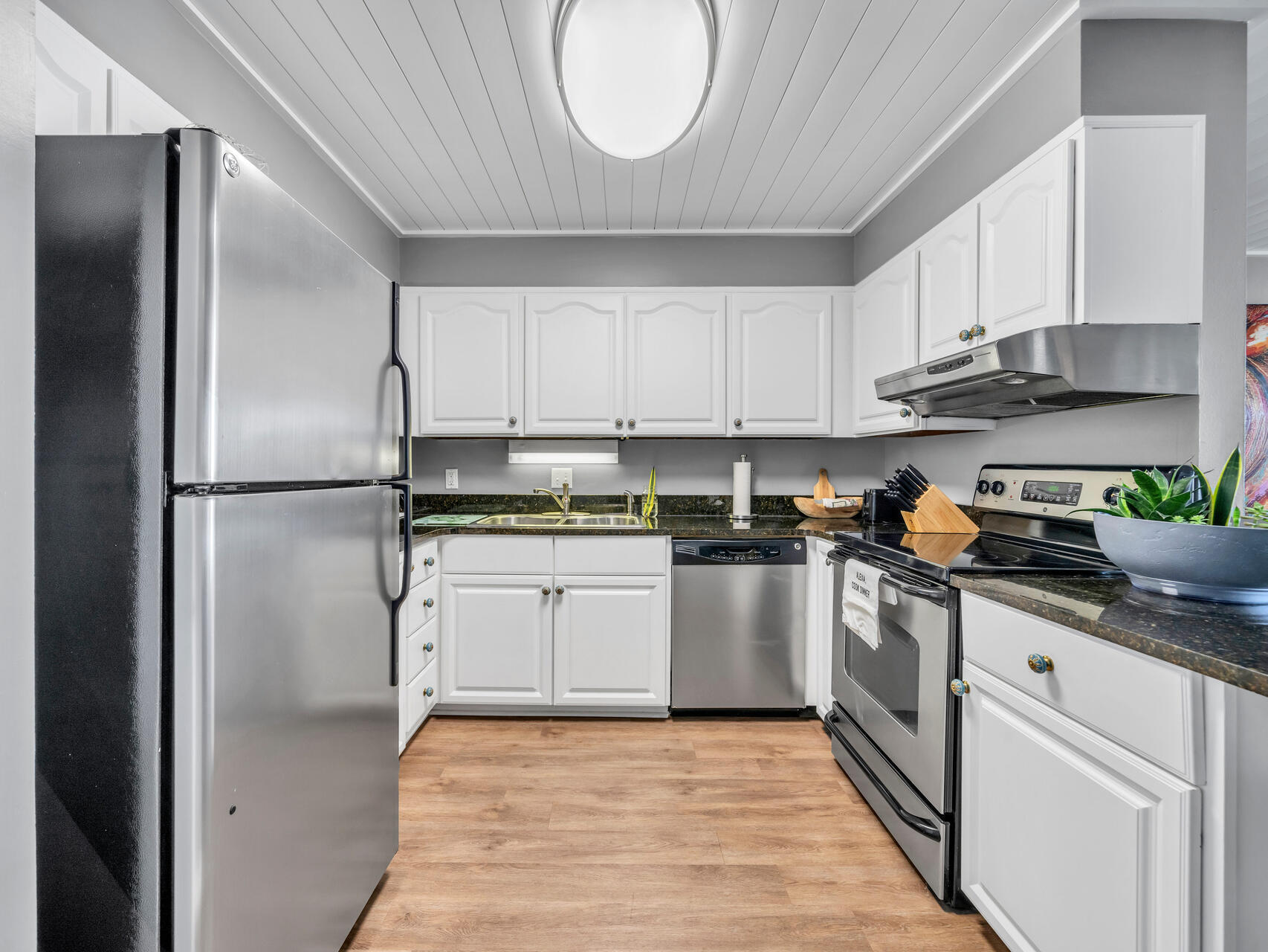 30 Moreno Point Road, Unit 403A Destin, FL 32541 - Photo 8 of 33 a kitchen with stainless steel appliances granite countertop a refrigerator sink and cabinets