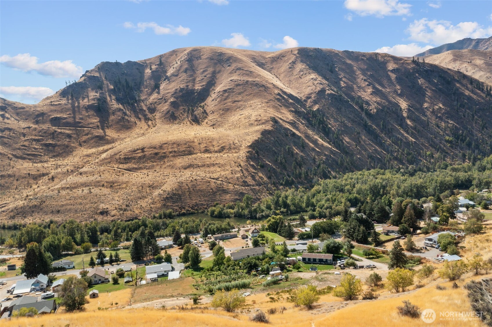 0 Entiat River Road, Unit LOT 5 Entiat, WA 98822 - Photo 28 of 36 a view of a houses with mountains in the background