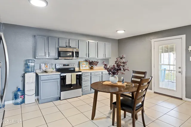 a kitchen with a refrigerator and a stove top oven