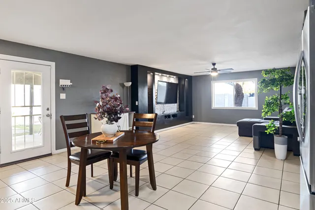 a view of a dining room with furniture and a potted plant