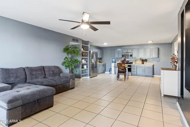 a living room with furniture and kitchen view