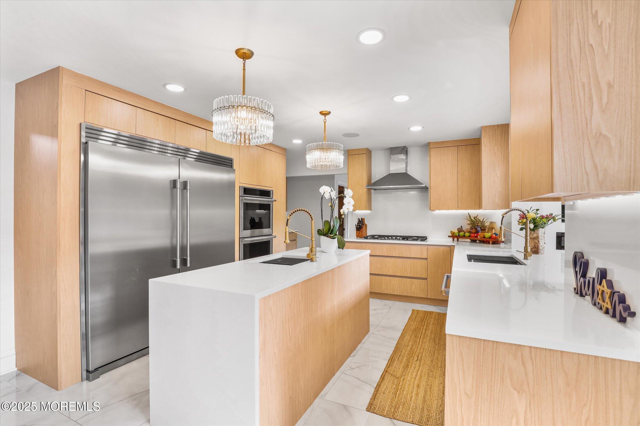 13 Valley Forge Road Eatontown, NJ 07724 - Photo 19 of 74 a large kitchen with stainless steel appliances kitchen island granite countertop a refrigerator a sink dishwasher a stove and a dining table with wooden floor