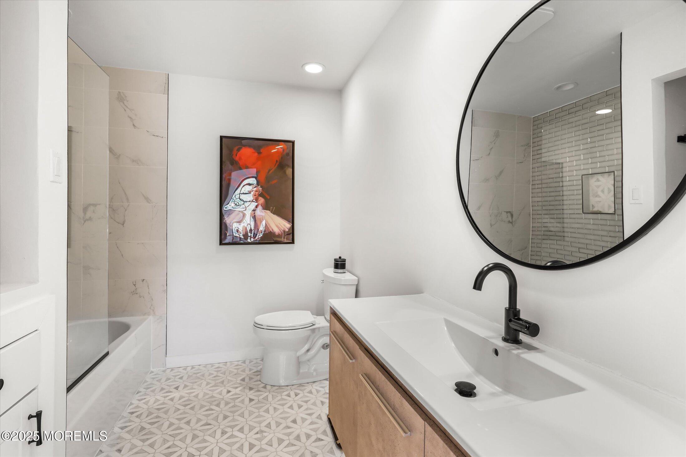 13 Valley Forge Road Eatontown, NJ 07724 - Photo 46 of 74 a bathroom with a sink a mirror and a toilet