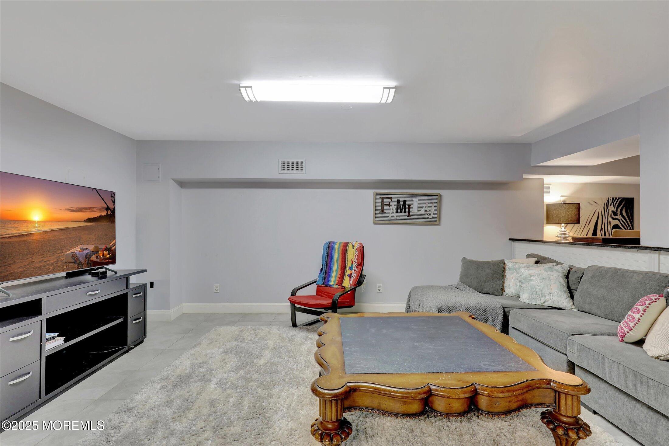 13 Valley Forge Road Eatontown, NJ 07724 - Photo 53 of 74 a living room with furniture and a flat screen tv