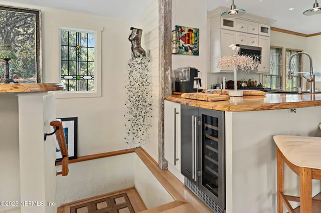 a view of a dining room with furniture a chandelier and window