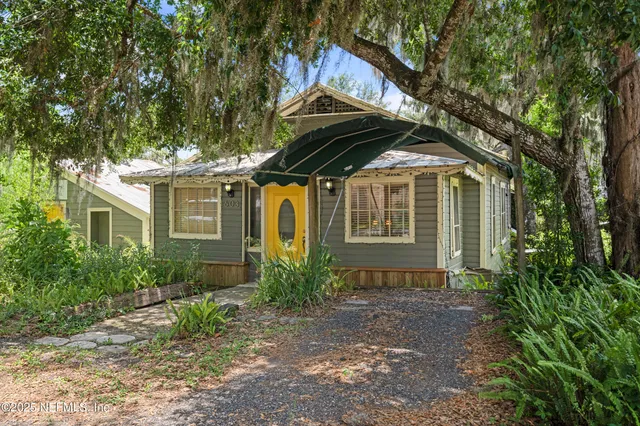 a open kitchen with stainless steel appliances granite countertop a stove a sink dishwasher a dining table and chairs with wooden floor