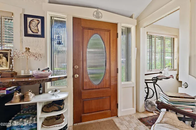a living room with fireplace furniture and a large window