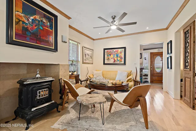 a living room with furniture a table and painting on the wall