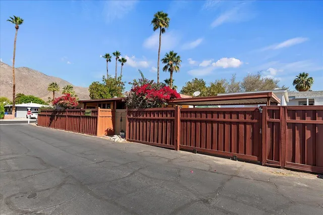 a view of a balcony with flower plants