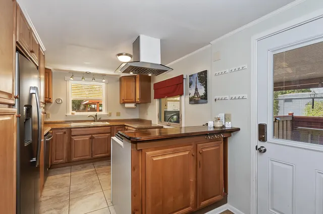 a kitchen with stainless steel appliances granite countertop a sink and cabinets