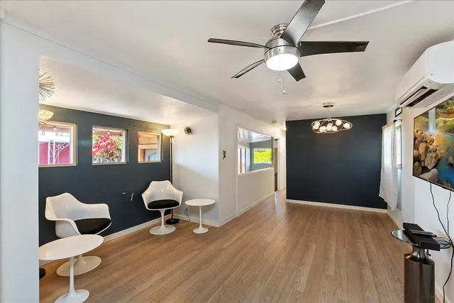 a view of a livingroom with furniture and a ceiling fan