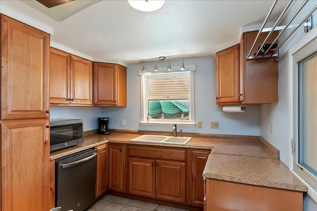 a kitchen with stainless steel appliances granite countertop a sink stove and cabinets